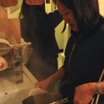 Lisa pours water for tea.
