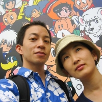 At Kyoto Station Waiting for the bus with friends from the Tezuka Museum sign.