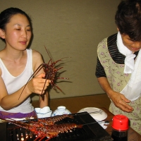 Mari holds a lobster We're a little uncomfortable as the lobster is about to get skewered.