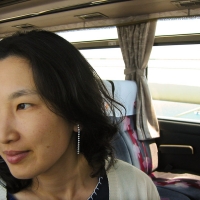 Mari Mari gazes out the bus window.