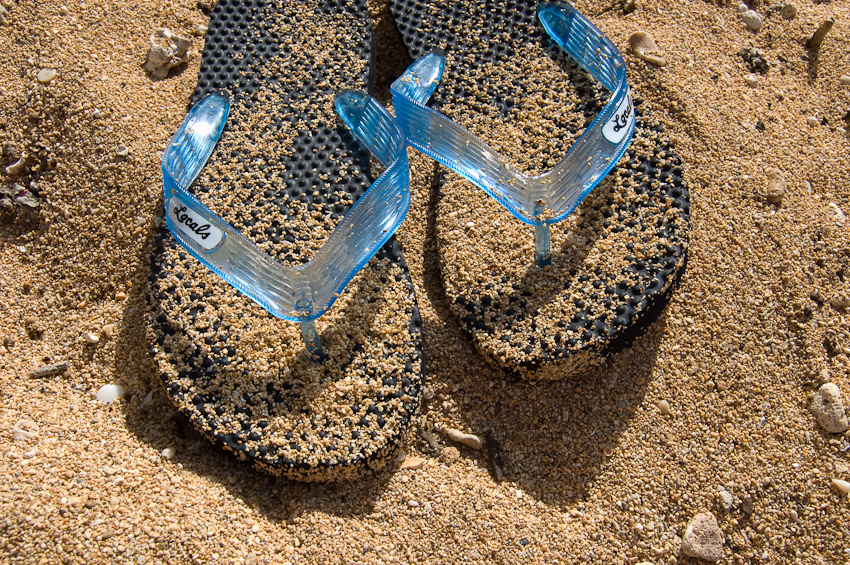 Flip-flops on the sand.